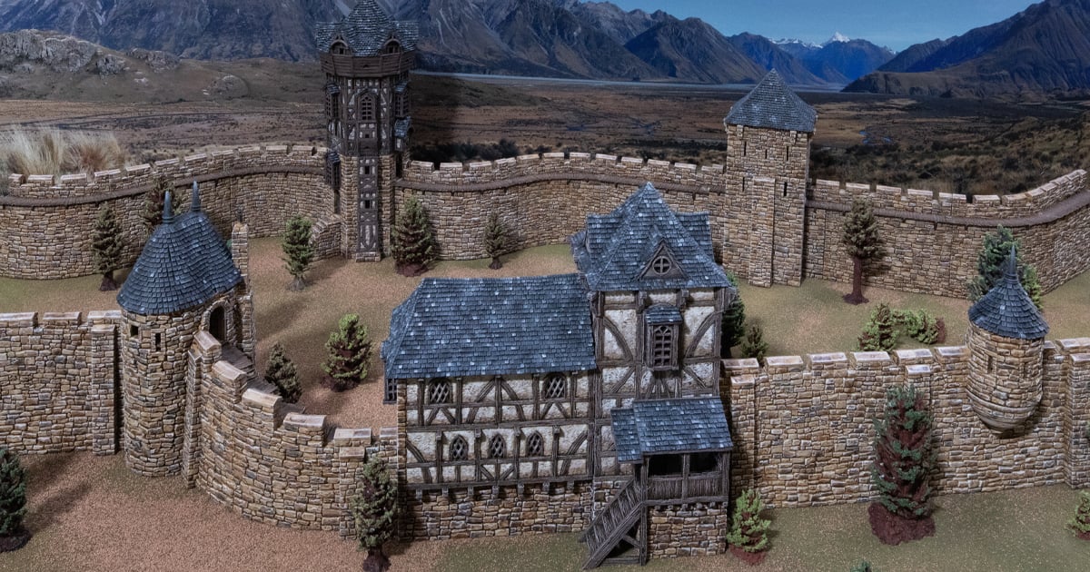 3D printed and painted Wattle & Daub Living Quarters model for wargames and rpgs on a mountain backdrop