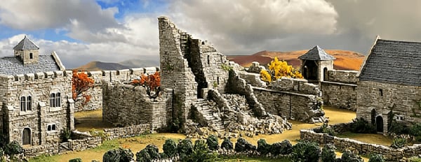 Historical Inspired 3D print of a Norman ruined building and terrain for wargaming with a sunny Autumn backdrop